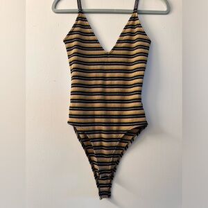 Glittery black and gold body suit